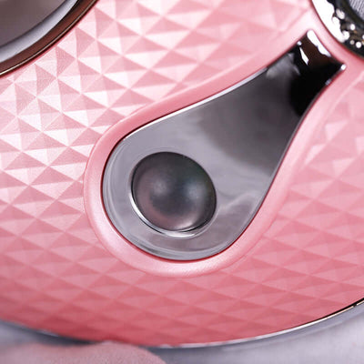 Close-up of the pink Ultrasonic beauty instrument showing the textured surface and control button for enhanced skincare.