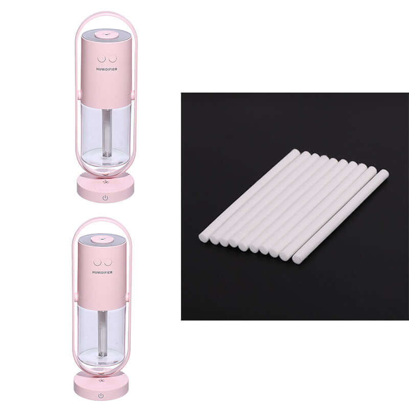 Anion humidifier in pink with cotton swabs, featuring a sleek design and compact size. Ideal for enhancing air quality.