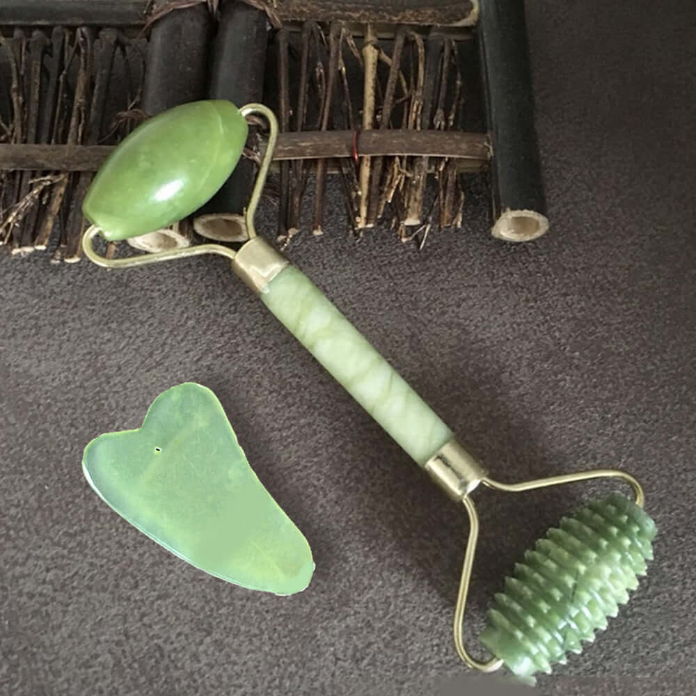 Green jade beauty container massager including roller and scraper for facial and body use.